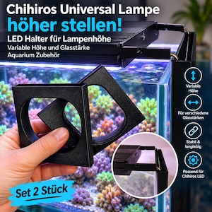 May include: A set of two black, square-shaped aquarium LED light holders with circular cutouts. The holders are designed for adjusting the height of aquarium lighting systems and are compatible with various glass thicknesses for tank mounting.