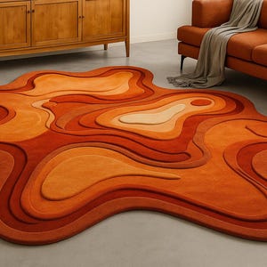 May include: An abstract area rug in shades of orange and rust. The rug has a layered, organic design with varying heights, creating a 3D effect. The rug's shape is irregular, adding to its modern aesthetic. The rug is placed on a grey floor. The rug's dimensions are in cm.