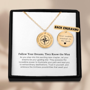 May include: Gold compass necklace with the inscription "Follow your dreams, they know the way". The back of the necklace can be engraved with a custom message. The necklace comes in a black box with a white background and the inscription "Follow Your Dreams, They Know the Way".