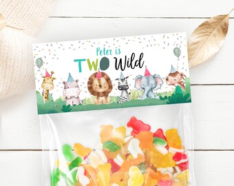 May include: A party favor bag with a green, white, and blue label that says "Peter is Two Wild". The label features a variety of cartoon animals wearing party hats. The bag is filled with colorful gummy candies.
