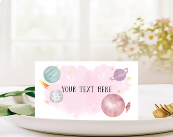 May include: A white card with a pink watercolor background and space-themed illustrations. The card features planets, stars, and a rocket ship. The text "YOUR TEXT HERE" is in the center.