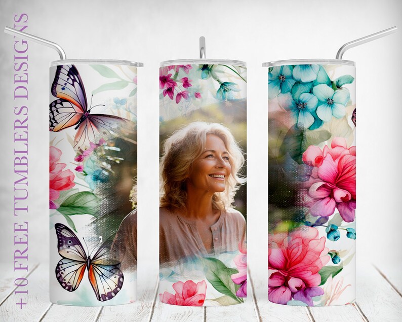 May include: Three stainless steel tumblers with a white background and floral designs. The designs feature butterflies, flowers, and a woman's face. The tumblers are 20 ounces each.