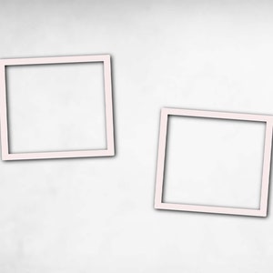 May include: Two white picture frames on a white background. The frames are square and have a simple, modern design.