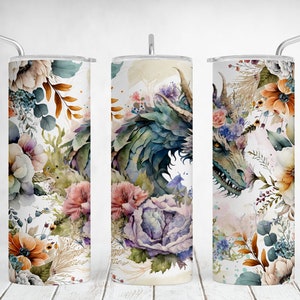 May include: Three cylindrical tumblers with lids and straws, featuring a watercolor print of a green dragon surrounded by various colorful flowers including orange, pink, and purple blossoms. The text +10 FREE TUMBLERS DESIGNS is visible.