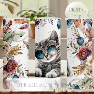 May include: White tumbler with a gray tabby cat wearing sunglasses with a galaxy design. The tumbler is decorated with watercolor floral and feather accents. Text on the tumbler reads "+ 10 FREE DESIGNS" and "DIGITAL FILE".