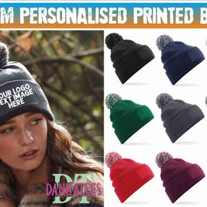 May include: A selection of custom printed beanies in various colours, such as black, navy, green, grey, red, and burgundy. Each beanie features a pom-pom and a patch for custom logos or text. One beanie displays the text "YOUR LOGO TEXT IMAGE HERE".