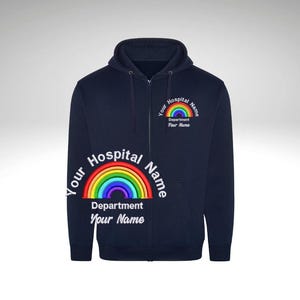 May include: Navy blue zip-up hoodie with a rainbow embroidered on the front. The rainbow has the text "Your Hospital Name" above it and "Department Your Name" below it.