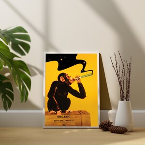 May include: A yellow and black poster with a cartoon monkey smoking a joint. The monkey is sitting on a wooden crate with the text "Organic Just Roll With It" and a marijuana leaf.