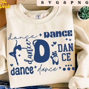 May include: Cream-colored sweatshirt with the word "DANCE" in navy blue, featuring a ballerina silhouette, ballet shoes, and stars. The words "SVG & PNG" and "DIGITAL DOWNLOAD" are also visible.