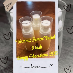 May include: Three clear glass bottles with yellow liquid and white pump tops. The bottles are labeled "Turmeric Lemon Facial Wash" and "Soapy Obsessions LLC". The image also includes the text "love" and hearts.