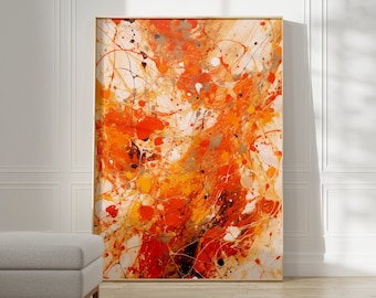 May include: Abstract painting with orange, yellow, and white paint splatters and streaks on a canvas. The painting is framed in a thin, gold frame.