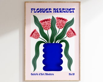 May include: A framed art print featuring a stylized floral arrangement. The artwork showcases a blue vase holding red and pink flowers with green leaves against a white background. The words "FLOWER MARKET" are in blue, and "Galerie d'Art Modern" is at the bottom.
