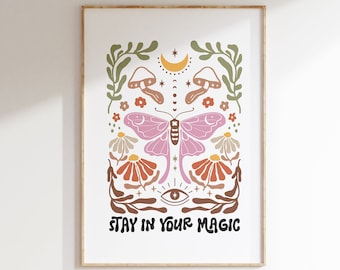 May include: A white poster with a colorful illustration of a butterfly, mushrooms, flowers, and a crescent moon. The text "STAY IN YOUR MAGIC" is at the bottom of the poster.