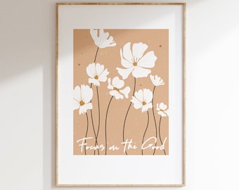 Può includere: Uno sfondo beige con fiori bianchi e il testo "Focus on the Good" in scrittura bianca.