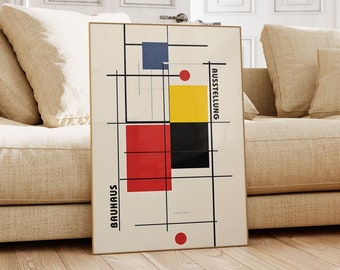 May include: A framed poster with a geometric design in red, yellow, blue, and black. The poster has the text "BAUHAUS" and "AUSSTELLUNG" on it.