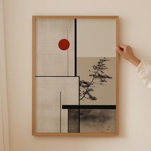 Può includere: Una stampa d'arte astratta incorniciata con un cerchio rosso, linee nere e una silhouette nera di un albero su uno sfondo beige.