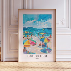 May include: A framed poster with a painting of a beach scene with colorful umbrellas and people. The poster is titled "Henri Matisse, Paris".