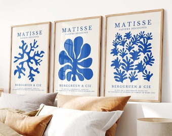 May include: Three framed art prints with blue abstract designs on a white background. The prints are titled "Matisse Papiers Decoupes" and feature the artist's name and the gallery's name, "Berggruen & Cie".