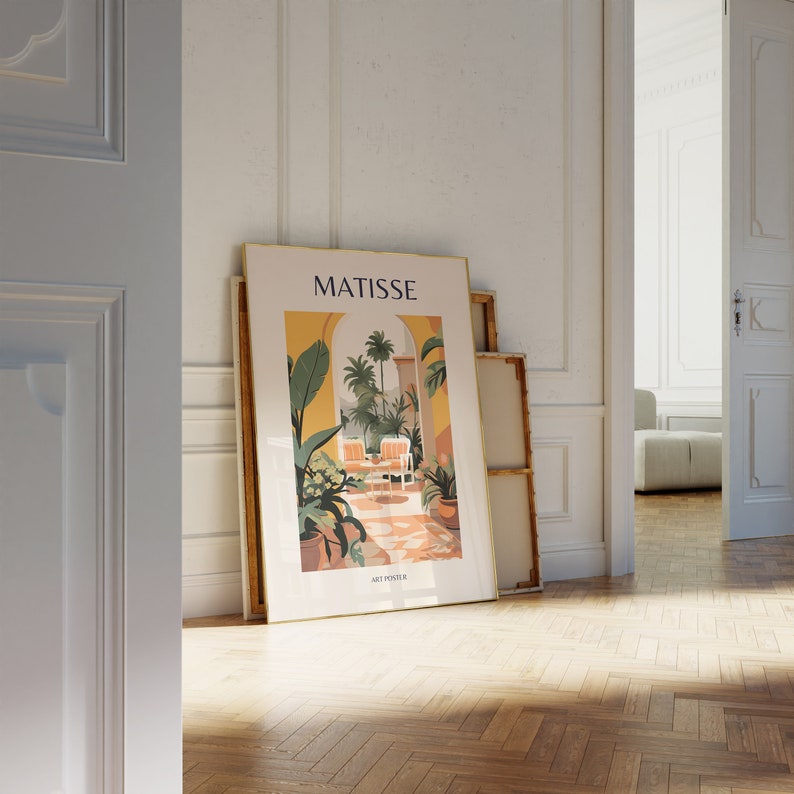 May include: A gold framed poster with a colorful illustration of a tropical garden with the text "MATISSE ART POSTER" at the bottom.