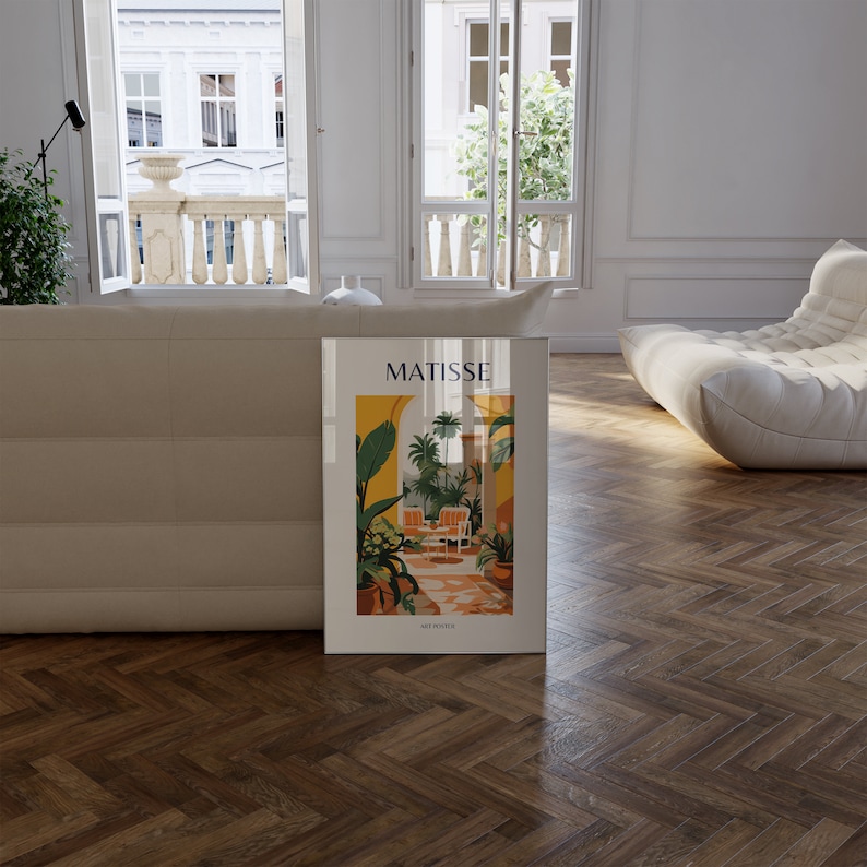 May include: A white framed poster with a colorful illustration of a tropical courtyard with the text "MATISSE ART PRINTS" at the bottom.