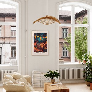 May include: A framed print of a painting depicting a night market scene with colourful lanterns and people walking through the street. The artist's name, Henri Matisse, is printed below the image.
