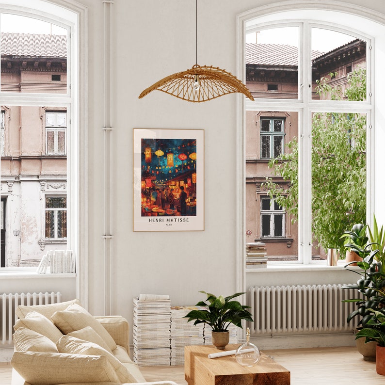 May include: A framed print of a painting depicting a night market scene with colourful lanterns and people walking through the street. The artist's name, Henri Matisse, is printed below the image.