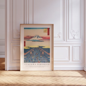 May include: A vintage Japanese woodblock print by Utagawa Hiroshige depicting a bustling street scene with Mount Fuji in the background. The print is titled "Suruga Street (Suruga-cho) from the series One Hundred Famous Views of Edo."