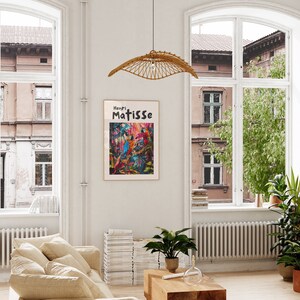 May include: A framed poster with a colorful painting of birds in a jungle setting. The poster has the text "Henri Matisse" at the top.