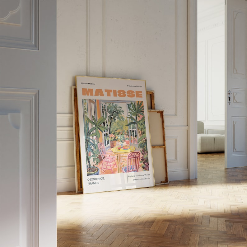 May include: A framed poster with a painting of a garden scene by Henri Matisse. The poster is titled "Matisse" and features the text "06200 Nice, France" and "Explore Matisse's World at MatisseEdition.com".