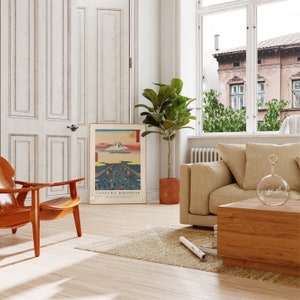 May include: A living room interior with a wooden coffee table, a beige sofa, a brown armchair, a potted plant, and a framed print of a Japanese landscape with the text "UTAGAGAWA HIROSHIGE".