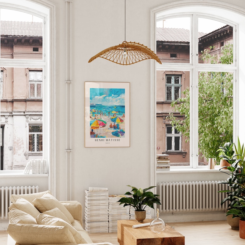 May include: A framed poster of a beach scene with colorful umbrellas and people. The poster is titled "Henri Matisse, Paris".