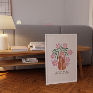 a picture of a vase with flowers on a coffee table