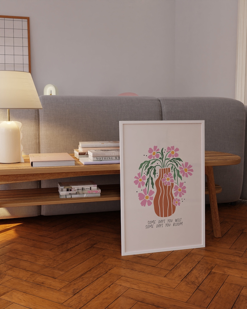 a picture of a vase with flowers on a coffee table