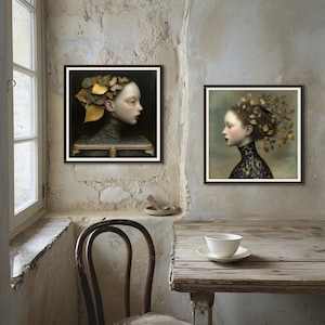 May include: Two framed art prints featuring portraits of women with elaborate leaf and floral headpieces. The portraits have a dark, moody aesthetic with a focus on the subjects' profiles. The artwork is displayed in a room with a rustic, vintage feel.