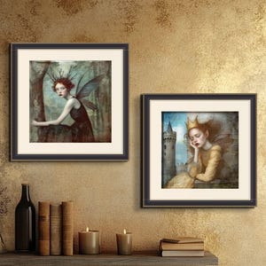May include: Two framed art prints featuring fantasy illustrations of women with wings. The first print shows a woman with red hair and blue wings sitting on a tree branch. The second print shows a woman with blonde hair and white wings sleeping with her head resting on her hand.