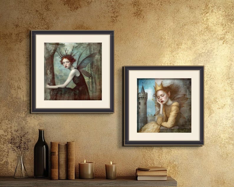 May include: Two framed art prints featuring fantasy illustrations of women with wings. The first print shows a woman with red hair and blue wings sitting on a tree branch. The second print shows a woman with blonde hair and white wings sleeping with her head resting on her hand.