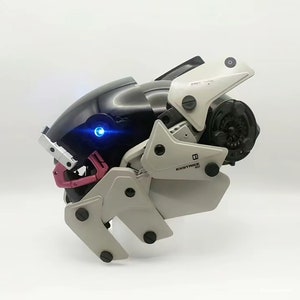 May include: A futuristic-looking helmet with a black and grey design. The helmet has a blue light on the front and the text "EX-STRIKE 01" on the side.