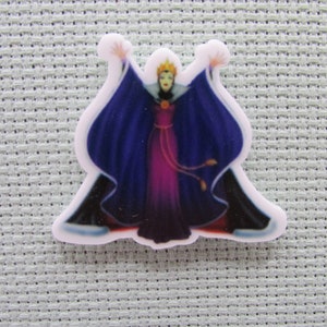 May include: A white plastic pin with a colorful image of the Evil Queen from Snow White. She is wearing a purple and blue gown and a crown. Her arms are raised in the air.