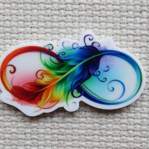 May include: A colorful, stylized infinity symbol with a feather design. The feather transitions from red to yellow, green, and blue. The design is on a white background with a textured surface.