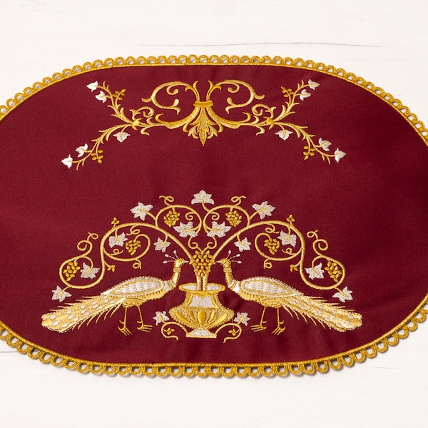 Embroidered placemat featuring Byzantine design on a rich burgundy satin background, Featuring an Elaborate Embroidered Border.