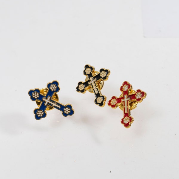 Bronze and enamel Christian pin, shaped like a cross, perfect for adorning clothing, available in three vibrant colors in a luxurious case.