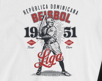 May include: White V-neck t-shirt with a vintage baseball graphic. The graphic features a baseball player in action, with the text "República Dominicana Beisbol 1951" and "Liga Profesionales" around the image.