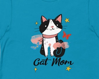 May include: A turquoise blue t-shirt with a black and white cat illustration wearing a pink scarf. The cat is surrounded by butterflies and stars. The text "Cat Mom" is printed below the cat.