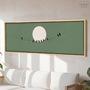 May include: A framed canvas print with a green background and a white circle in the center. A line of black birds are perched on a wire in front of the circle.