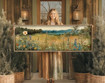 May include: A long, rectangular landscape painting featuring a vibrant meadow filled with colorful wildflowers, including white, orange, and blue blossoms, set against a backdrop of rolling green hills, distant blue mountains, and a soft sky.