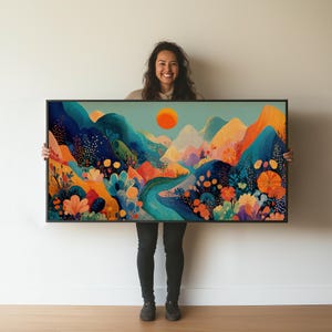 May include: A framed art print featuring a colorful landscape with mountains, a river, and a bright orange sun. The artwork uses a vibrant palette of blues, oranges, and greens, creating a cheerful and inviting scene. The frame is black.