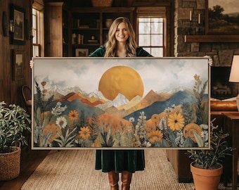 May include: A rectangular framed wall art piece featuring a landscape illustration of layered mountains under a large golden sun, with a foreground filled with detailed wildflowers in shades of orange, yellow, and green against a cloudy sky.