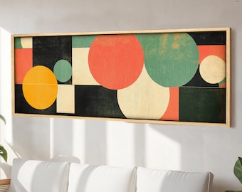 May include: Abstract geometric art print with a black background, featuring overlapping circles in shades of red, yellow, green, and cream. The print is framed in a natural wood frame.