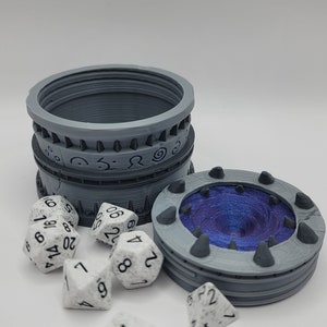May include: A gray, 3D printed dice tower with a swirling blue and purple interior. The tower is open and six white dice with black numbers are scattered around it.
