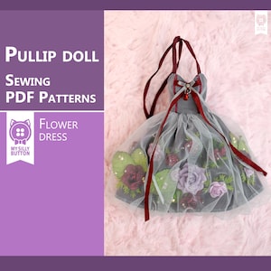 May include: A gray and white flower dress with red ribbon accents for a Pullip doll. The dress is decorated with fabric flowers and green leaves. The dress is part of a sewing pattern for a doll.